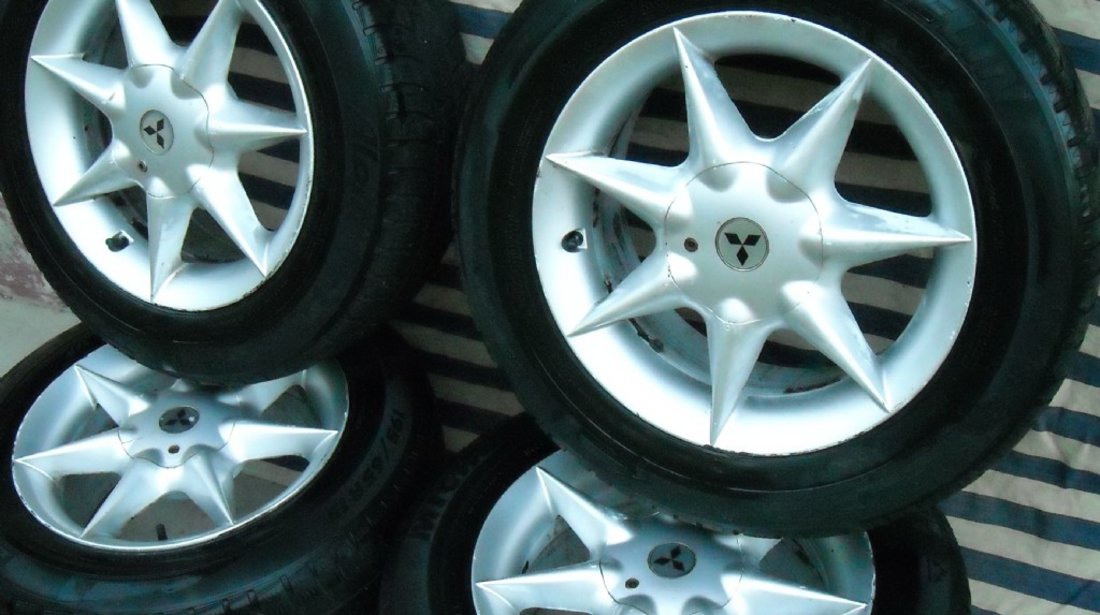 JANTE aliaj pe 15 originale MITSUBISHI cu anvelope iarna MICHELIN Neg