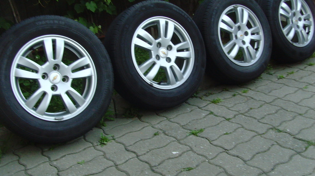 Jante de aliaj ca Noi 4x100 pe 15 originale Chevrolet Aveo T300 din2012+anvelope vara 195/65R15