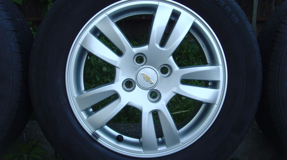 Jante de aliaj ca Noi 4x100 pe 15 originale Chevrolet Aveo T300 din2012+anvelope vara 195/65R15