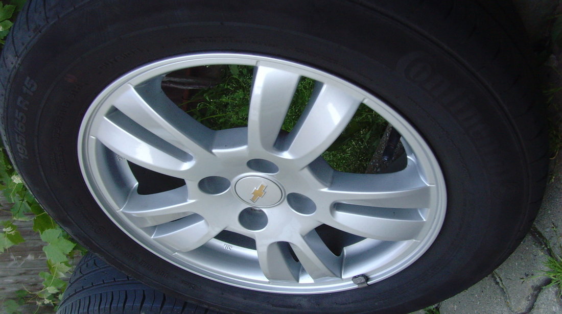 Jante de aliaj ca Noi 4x100 pe 15 originale Chevrolet Aveo T300 din2012+anvelope vara 195/65R15