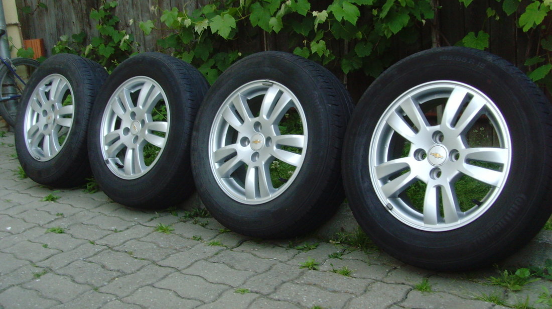 Jante de aliaj ca Noi 4x100 pe 15 originale Chevrolet Aveo T300 din2012+anvelope vara 195/65R15