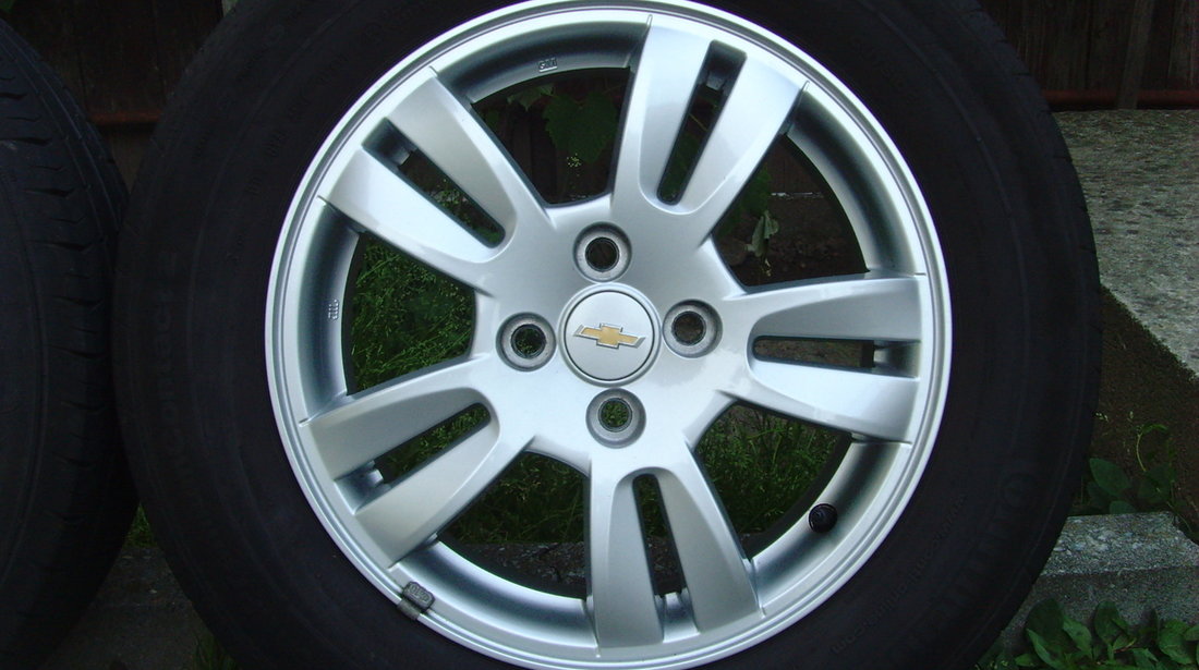 Jante de aliaj ca Noi 4x100 pe 15 originale Chevrolet Aveo T300 din2012+anvelope vara 195/65R15