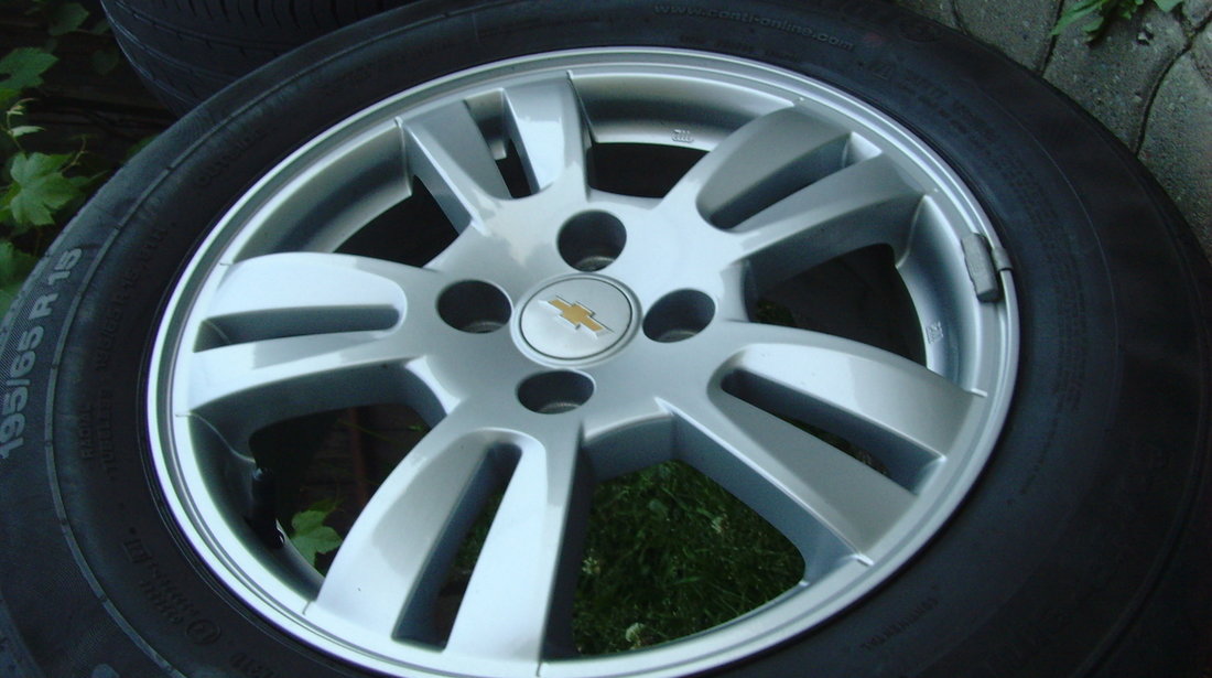 Jante de aliaj ca Noi 4x100 pe 15 originale Chevrolet Aveo T300 din2012+anvelope vara 195/65R15